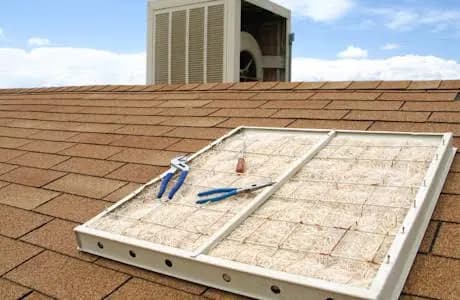 Evaporative cooler pad frame removed for replacement